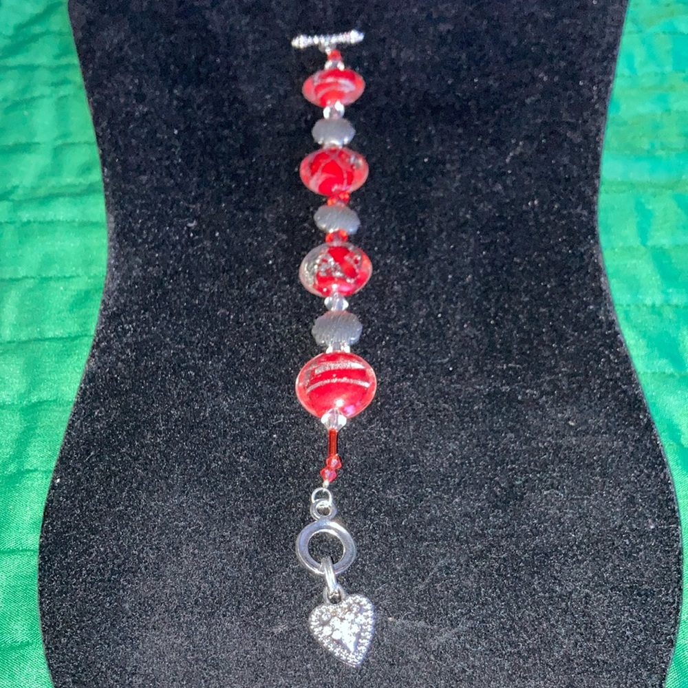 HAND CRAFTED MURANO red w/silver glass and st round beads w/toggle closing.  $30